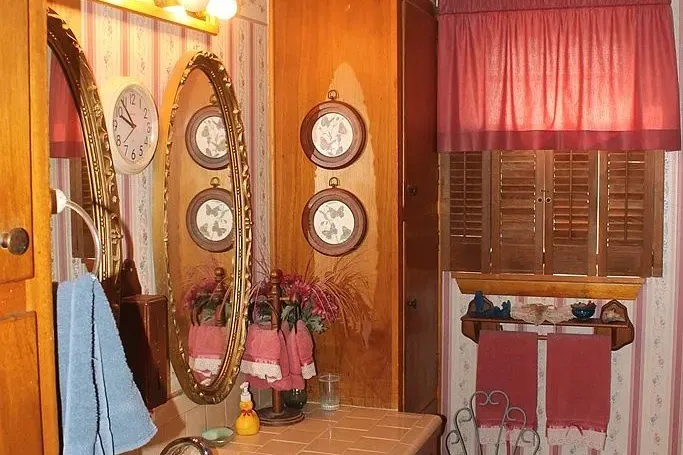 Bathroom before the remodel, with dark wood cabinetry